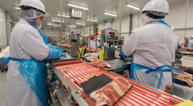 Two employees working at the Lagimodiere facility.