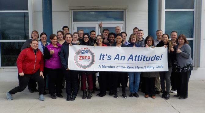 Zero Hero Club members holding club banner