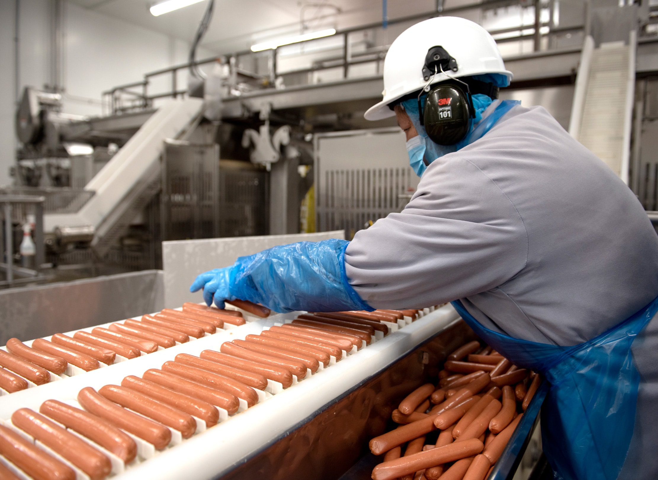 Employee working on wiener production line at Heritage plant.