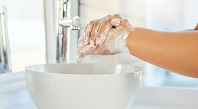 Washing hands with soap.