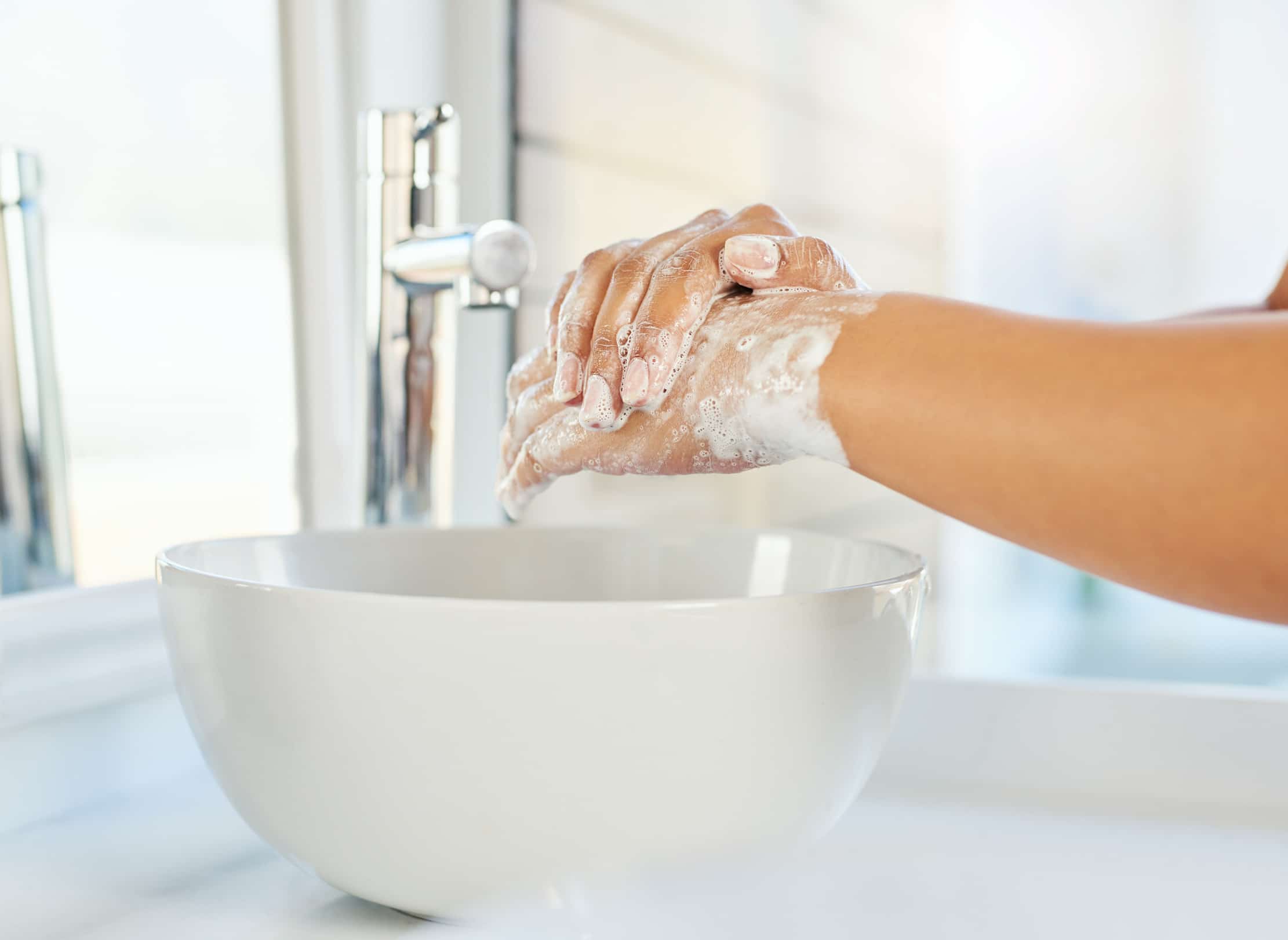 Washing hands with soap.