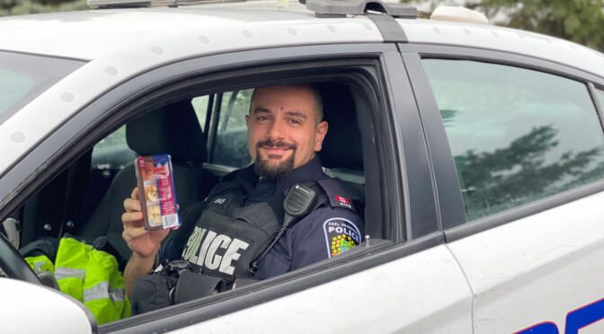 Police Officer receiving a Schneiders' Protein Pack.