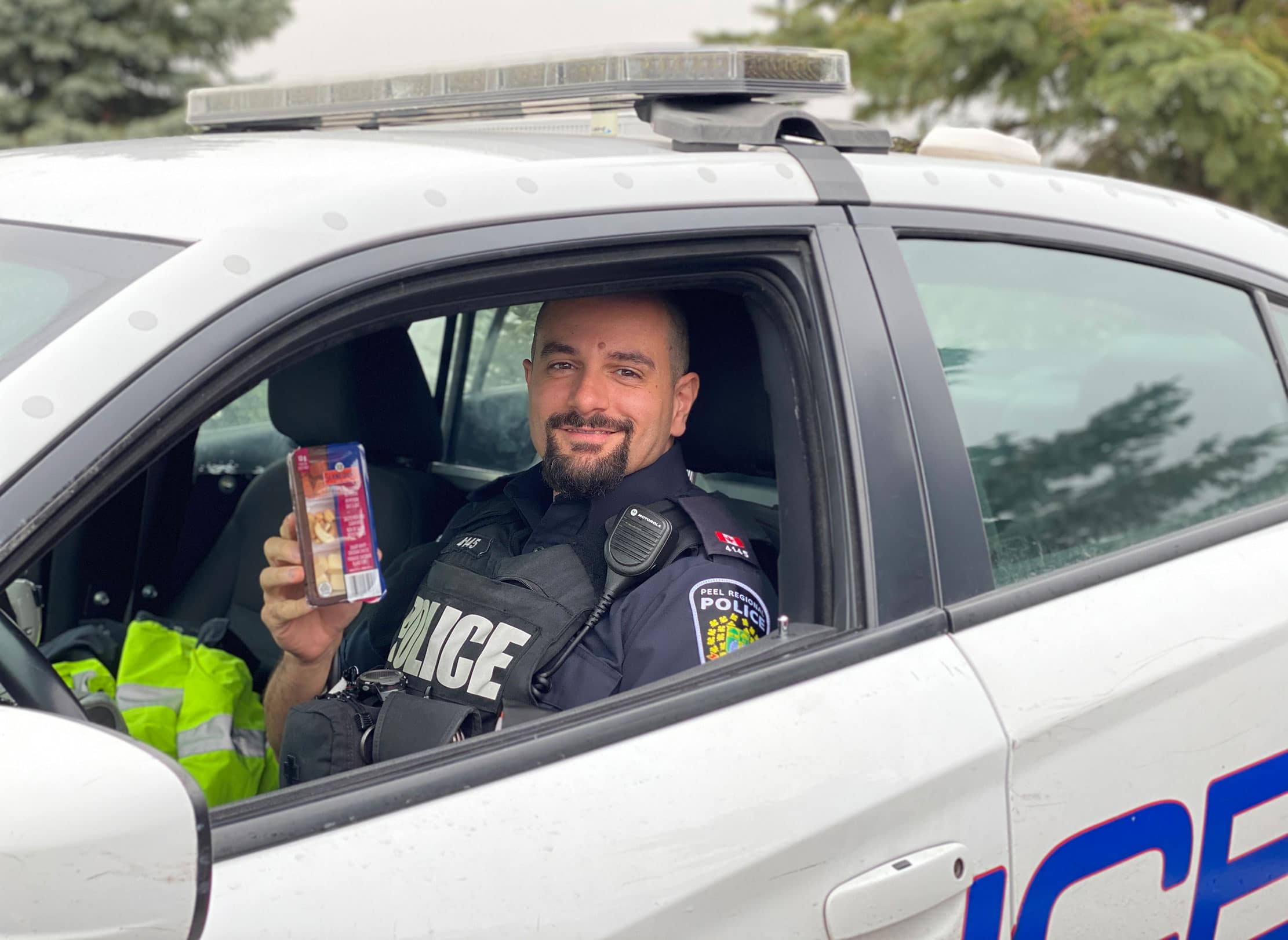 Police Officer receiving a Schneiders' Protein Pack.