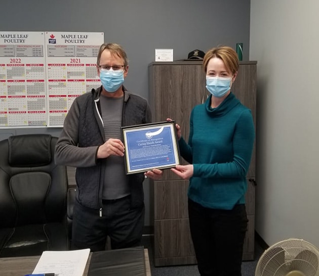 employee receiving animal care monthly caring hands award