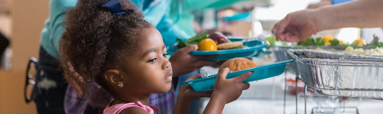 Young girl being served food
