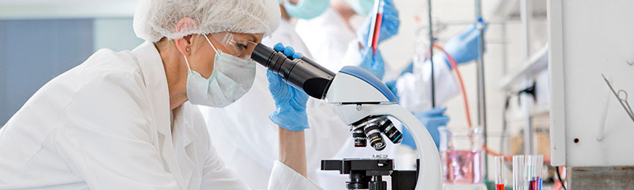 Scientist looking through a microscope