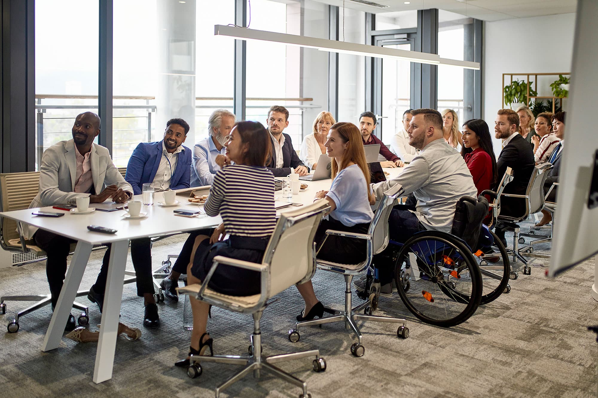 diverse group of people sitting around a meeting table