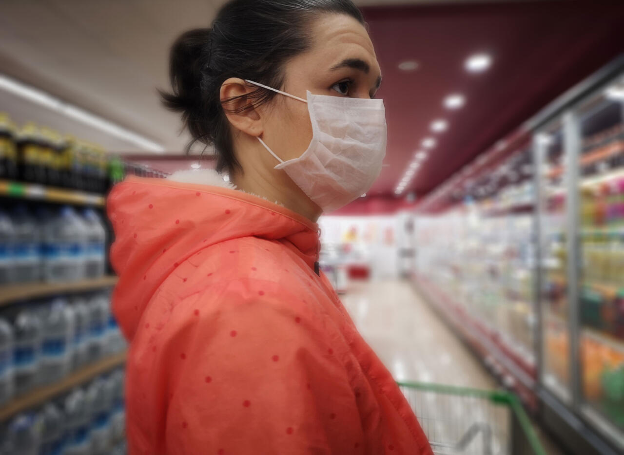 Woman in a supermarket wearing a mask