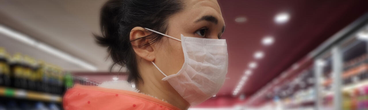 Woman in a supermarket wearing a mask