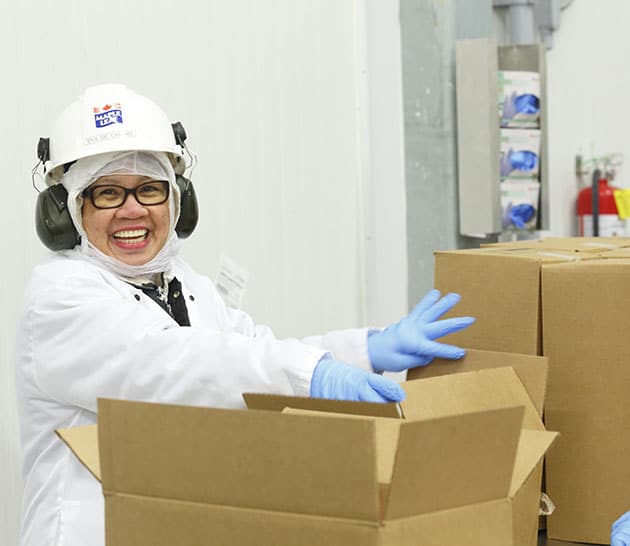 A worker packing product at our Guelph plant