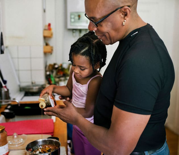 Dad and daughter cooking in kitchen