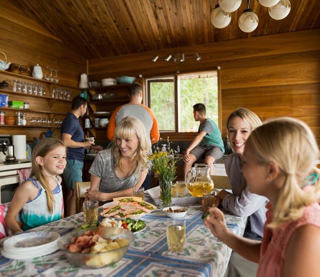 Family eating lunch at a cabin.