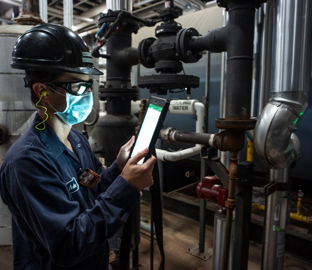 Examining pipes at Hamilton manufacturing plant