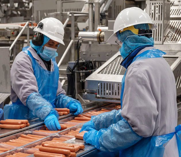 Making hot dogs at Maple Leaf Foods manufacturing plant in Hamilton