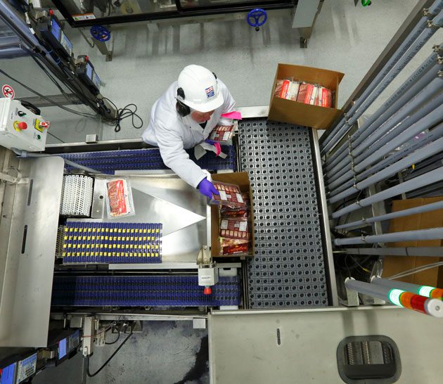 Packing product at Maple Leaf Saskatoon manufacturing plant.