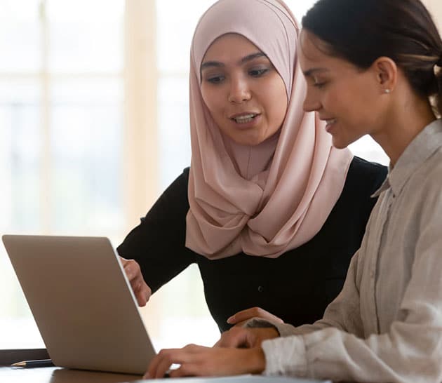 Two ladies in front of a laptop