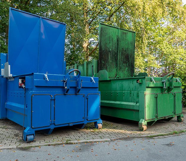 Blue and green recycle dumpsters