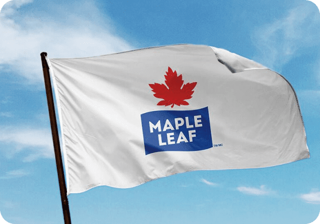 Maple Leaf Foods flag blowing in the blue sky