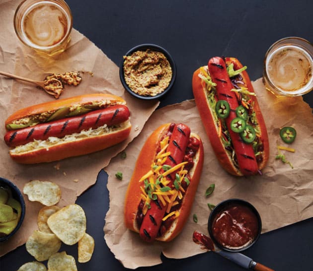 Schneiders Juicy Jumbos hot dogs in buns with toppings