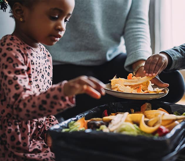 young girl composting waste