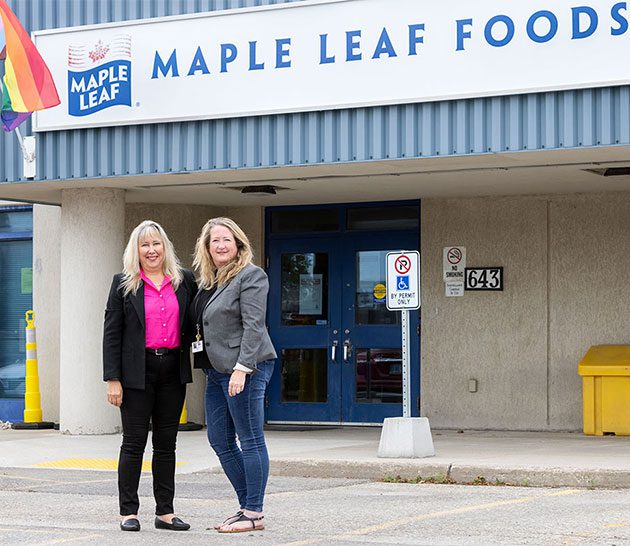 Debbie Slater and Rosemary Tessmer in front of Maple Leaf Foods plant