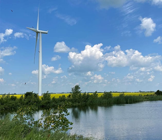 blue sky over a lake with a windmill