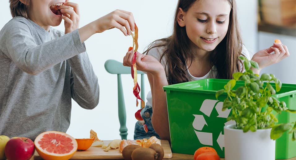 kids recycling compost in kitchen