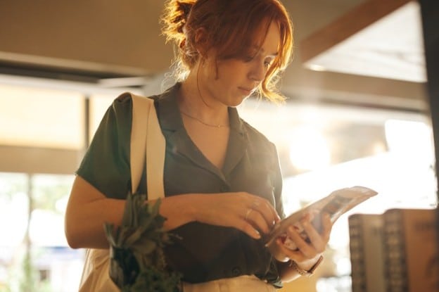 Woman looking at nutritional information on food packaging