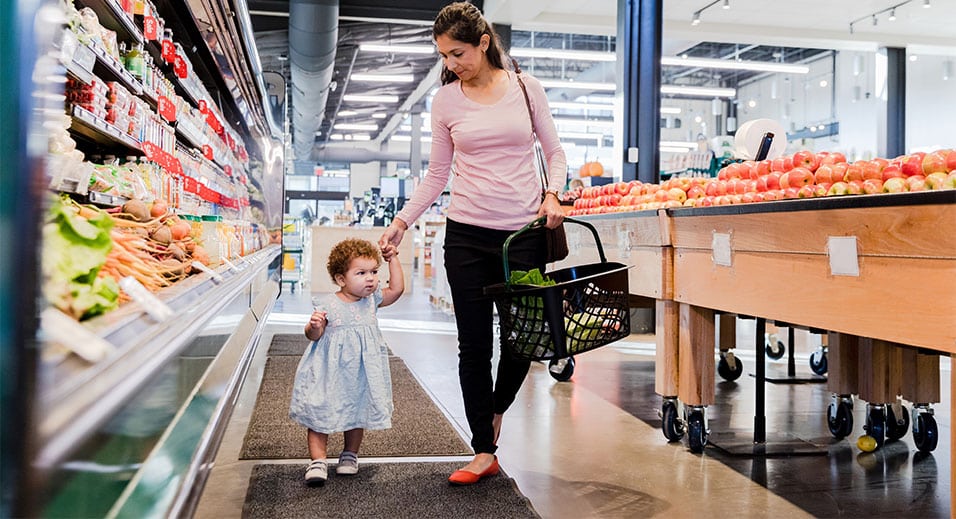 mother and toddler shopping in grocery store