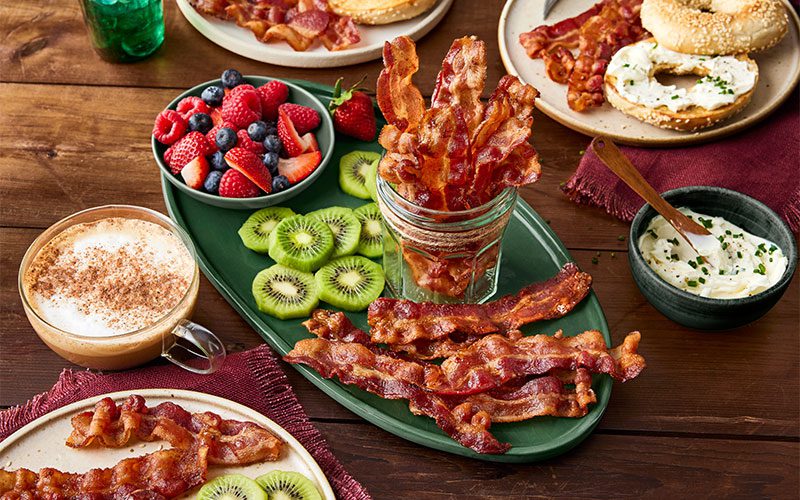 breakfast foods with bacon and fruit on the sides
