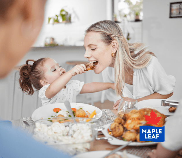 Mothe and child eating chicken