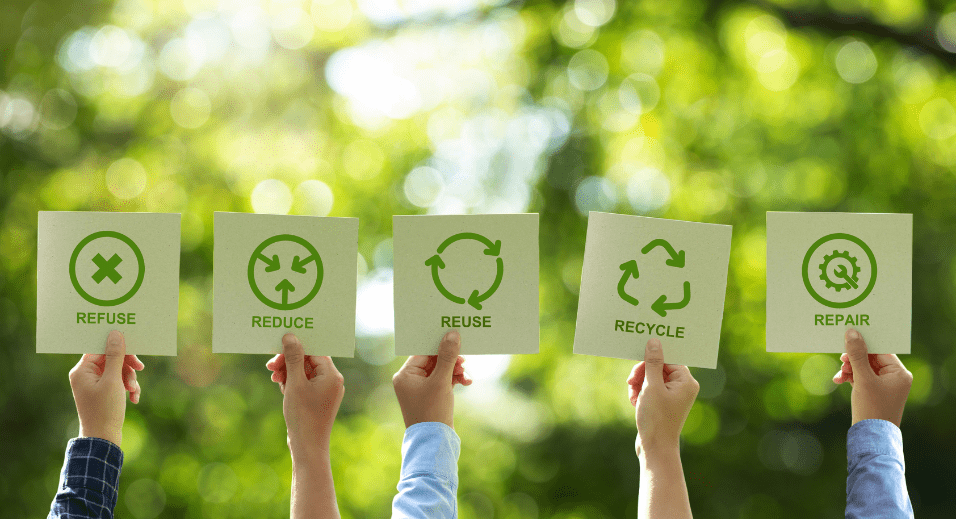 Hands holding recycling signage