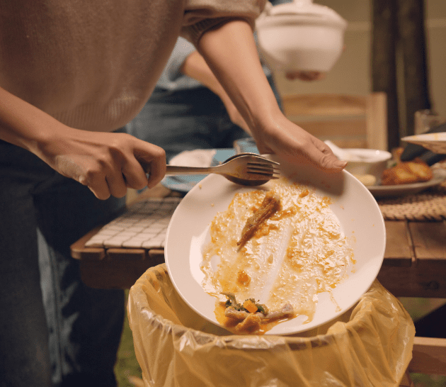 Person emptying food into trash