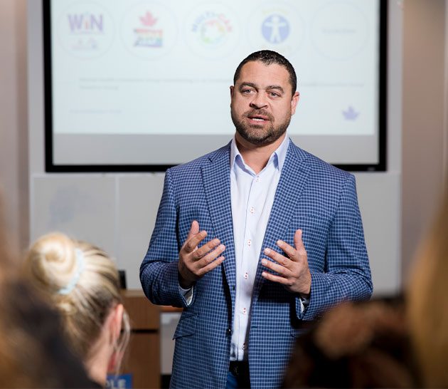 Josh Adams presenting to an audience