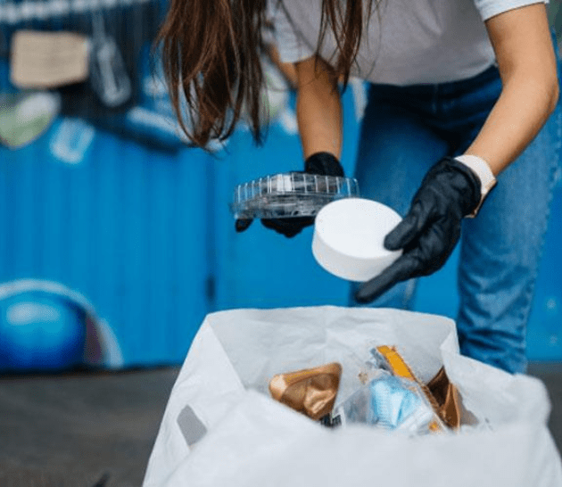 Person sorting through recycling.