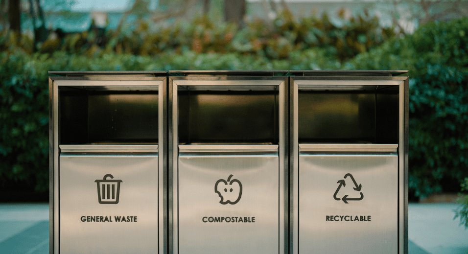 Garbage can with trash, compost, and recycling.